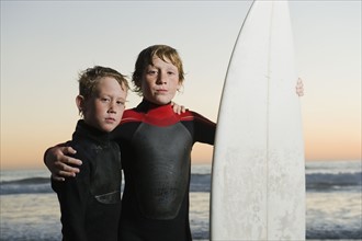 Children posed with surfboard