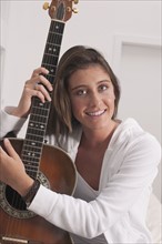 Young woman holding guitar