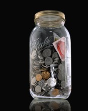 Jar of coins and condoms