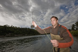 Fly fisherman casting