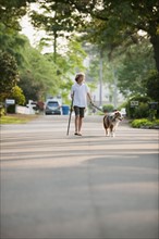 Boy walking dog