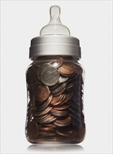 Baby bottle full of coins