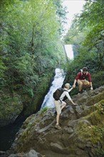 Hikers in front of waterfall
