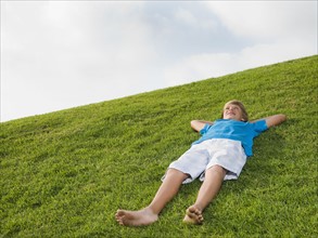 Boy resting on grass
