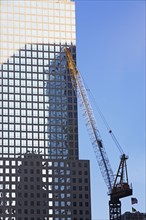 Crane beside skyscraper