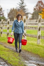 Woman carrying buckets.