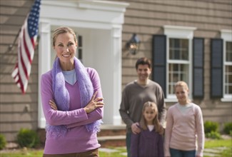 Family in front of house.