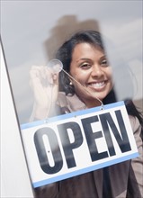 Woman behind open sign