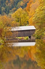 Bridge and reflection of fall foliage