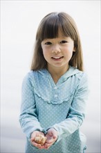 Young girl holding seashell