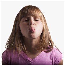 Young girl sticking tongue out