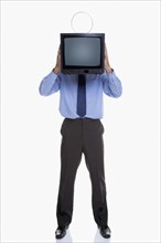 Man holding television in front of face