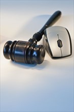 Computer mouse and gavel.