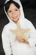 Boy holding starfish