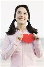 Young girl holding heart