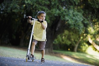 Boy riding scooter