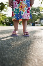 Young girl wearing flip flops
