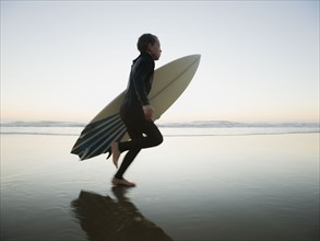 Child running with surfboard