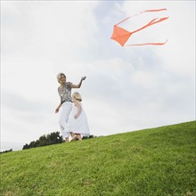 Mother and daughter flying kite