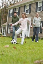 Family playing soccer.