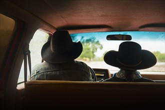 Cowboy and cowgirl in truck.