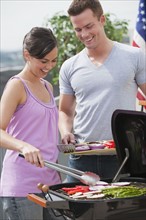 Couple barbequing.