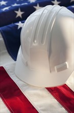 Hard hat on top of American flag.