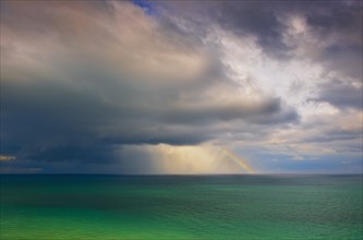 Rainbow over ocean.