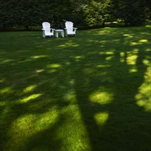 Adirondack chairs on lawn.