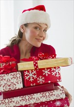 Woman holding Christmas presents.