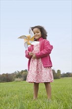 Girl playing with toy windmill. Photographer: Pauline St.Denis