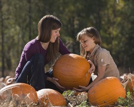 Mother and daughter in pumpkin patch. Photographer: Mike Kemp