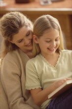 Mother and daughter reading together. Photographer: Rob Lewine