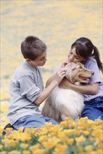 Children with dog in meadow. Photographer: Rob Lewine
