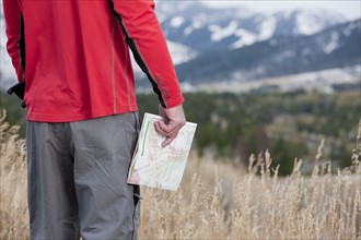 Hiker holding a map. Photographer: Dan Bannister