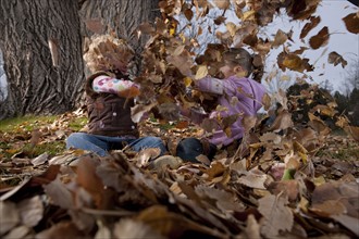 Girls playing in leaves. Photographer: Dan Bannister