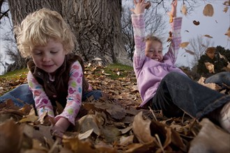 Girls playing in leaves. Photographer: Dan Bannister
