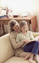 Mother and daughter reading a book. Photographer: Rob Lewine