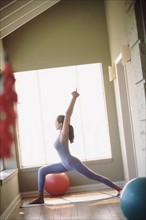 Woman doing yoga pose. Photographer: Rob Lewine