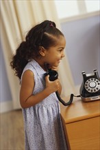 Young girl talking on telephone. Photographer: Rob Lewine