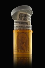 Money in prescription bottle. Photographer: Mike Kemp
