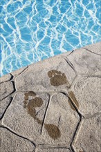 Footprints by the pool. Photographer: Chris Hackett