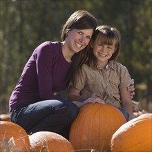 Mother and daughter in pumpkin patch. Photographer: Mike Kemp