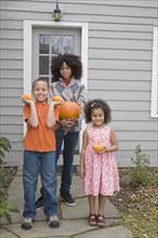 Family holding pumpkins. Photographer: Pauline St.Denis
