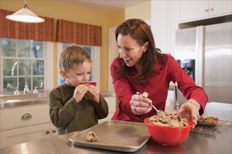 Mother and son baking cookies. Photographer: mark edward atkinson