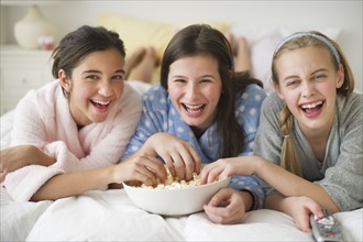 Girls eating popcorn.