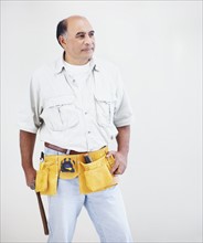 Man wearing tool belt. Photographer: momentimages