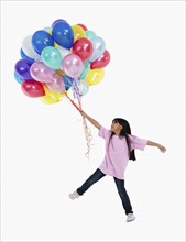 Girl holding balloons. Photographer: momentimages