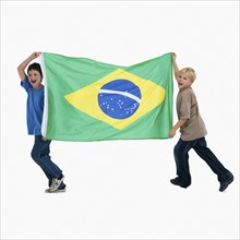 Two boys carrying flag. Photographer: momentimages
