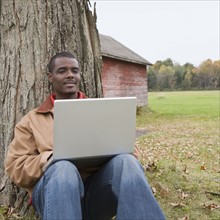 Man using laptop outside. Photographer: Pauline St.Denis